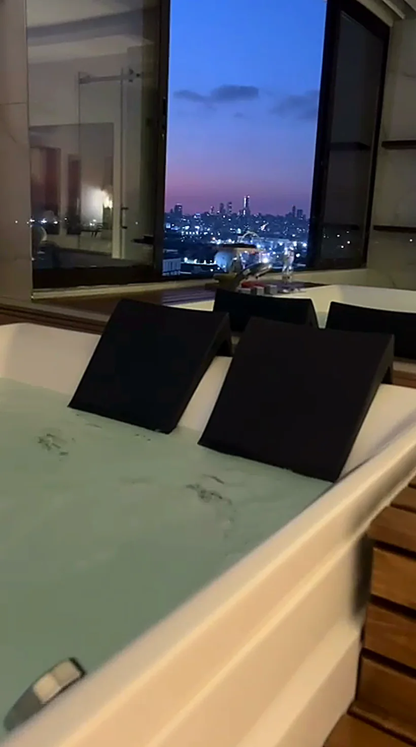 A champagne flute above the jacuzzi at dusk